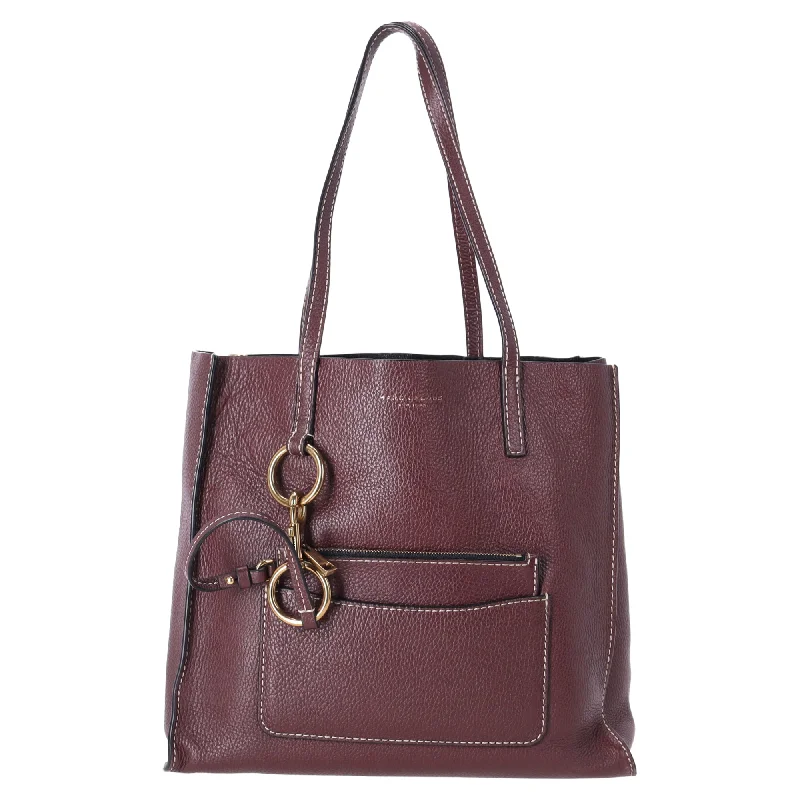 Handle bags with retro logos for charm -Handle bags with hidden pockets for extra security -Marc Jacobs The Bold Grind E/W Shopper Bag in Burgundy Leather